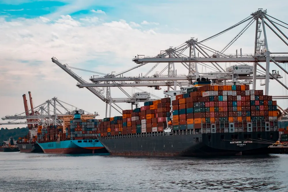 Cargo vessels berthed at a container terminal during loading